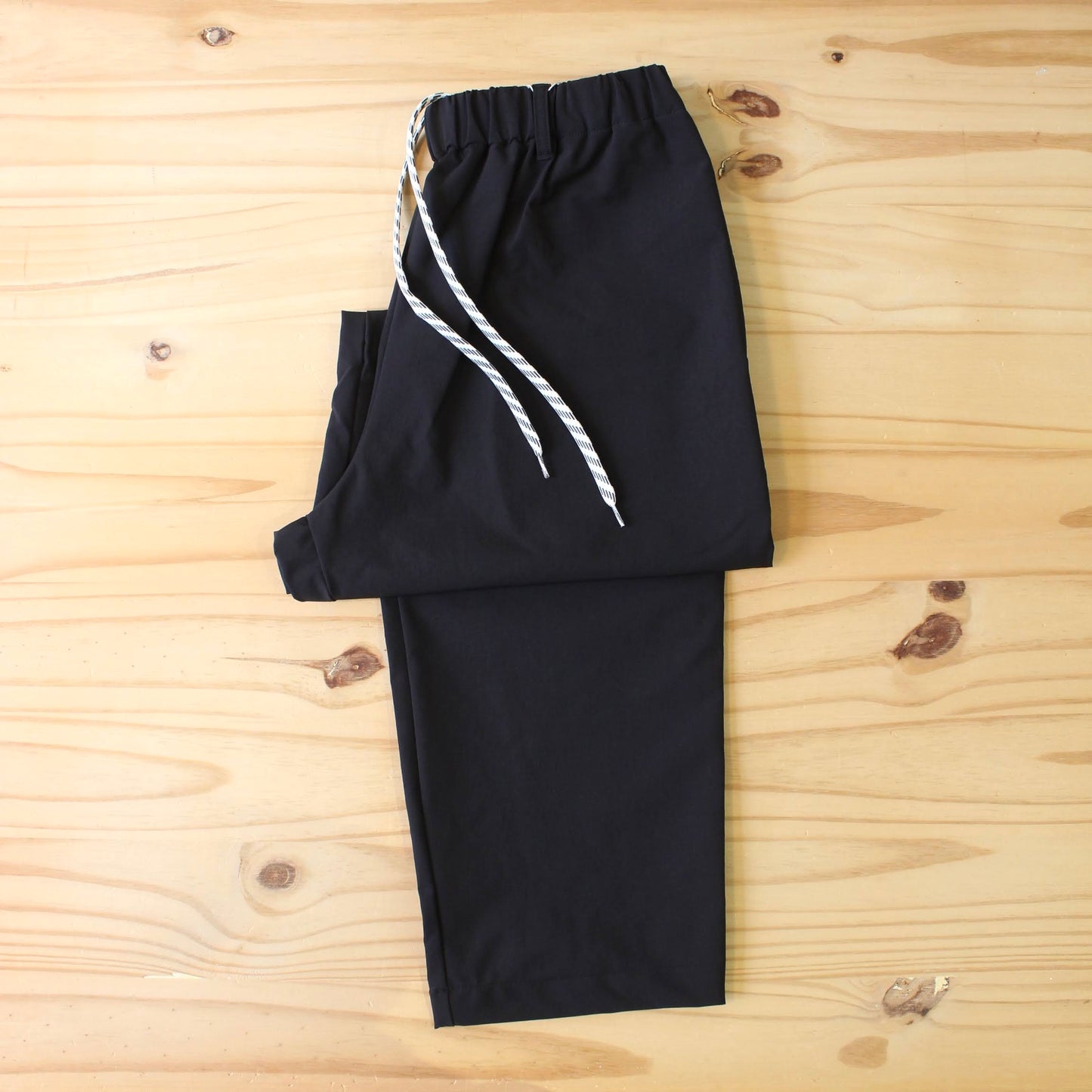 MANUAL ALPHABET -
4WAY NYLON EASY TAPERED PANTS