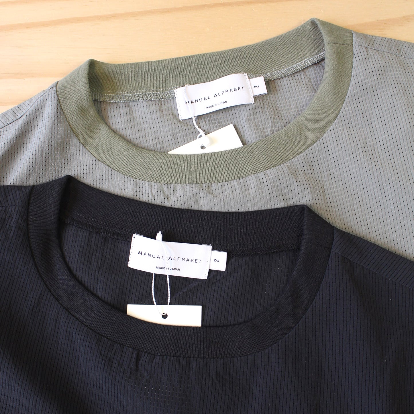 MANUAL ALPHABET -
DOT AIR PULLOVER MESH TEE